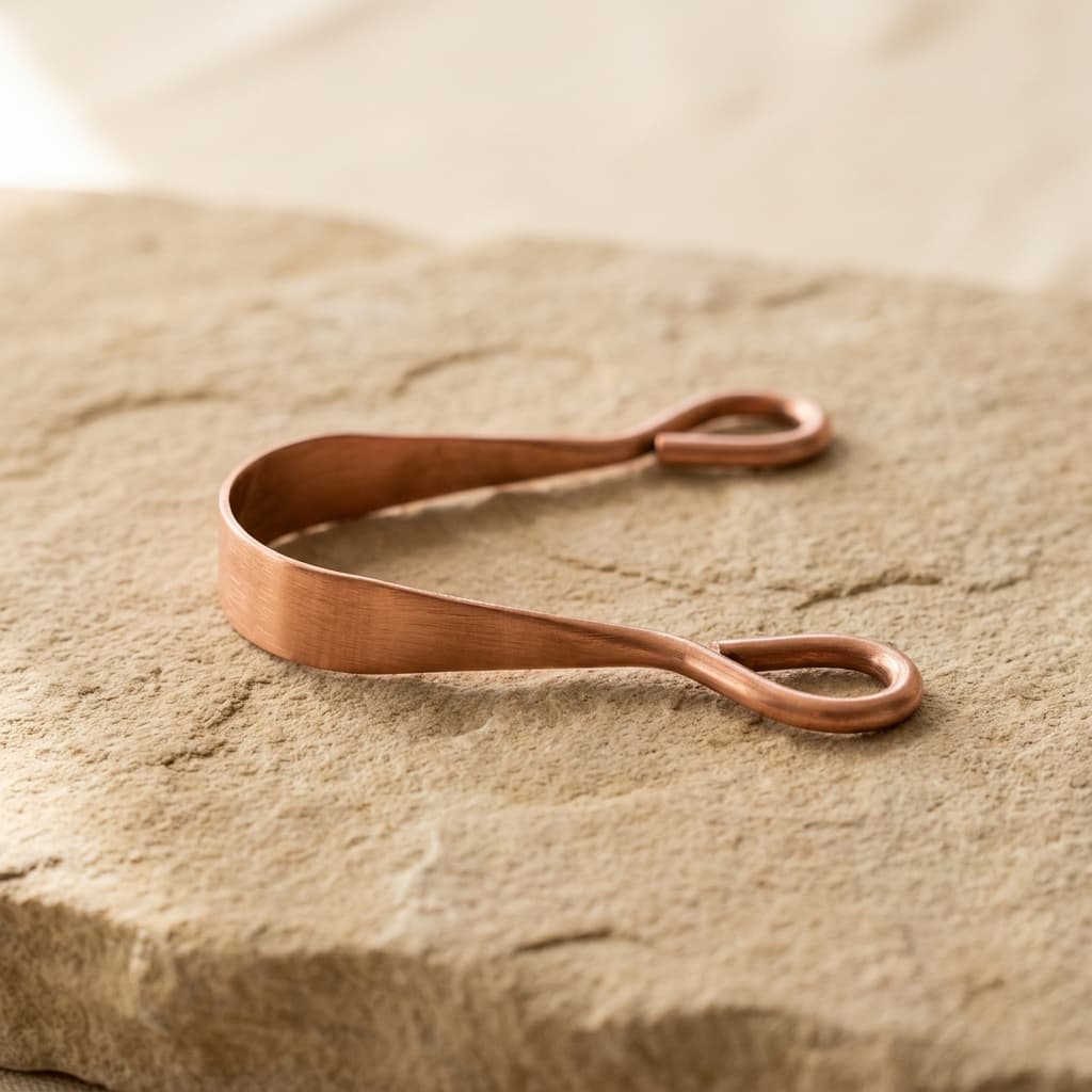 KHA Pure Copper Tongue Scraper oral cleansing tool on limestone